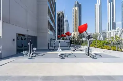 a group of chairs sitting on the side of a building at Vogue Downtown Mag 318 near Burj Khalifa and Dubai Mall, Studio Apartment with Balcony, Canal and City View, Access to all Amenities in Sabkhah