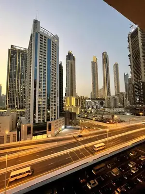 a view of a city with tall buildings and highways at Vogue Downtown Mag318 near Burj Khalifa and Dubai Mall, Studio Apartment with Balcony, Canal and City View, Access to all Amenities in Sabkhah