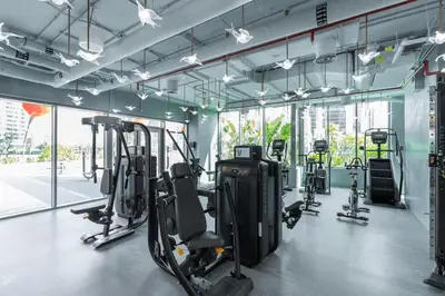 a gym with several treadmills and elliptical machines at Vogue Downtown Mag318 near Burj Khalifa and Dubai Mall, Studio Apartment with Balcony, Canal and City View, Access to all Amenities in Sabkhah