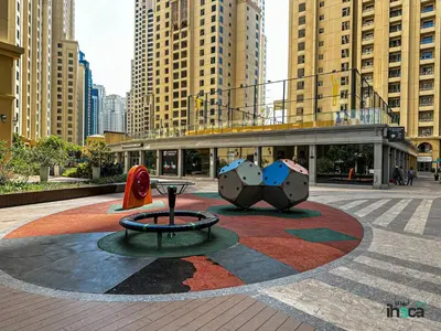 a city square with a sculpture in front of a building at Boho Studio Beachfront Ain Sea View JBR Walk 1min in Dubai