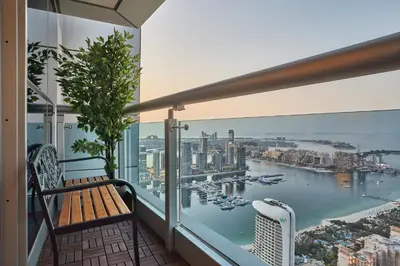 a balcony with a bench and a view of a harbor at Zen Den - Vintage Charm with full Sea View in Dubai