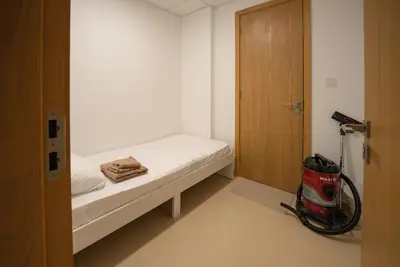 a small white room with a bed and a vacuum at Luxury 2bdr apartment with Burj views & resort amenities in Dubai