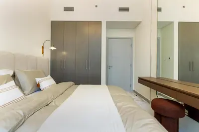 a bedroom with a large bed and a mirror at 313 Downtown Luxury Living at it's Finest in Dubai