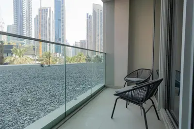 a balcony with two chairs and a view of the ocean at 313 Downtown Luxury Living at it's Finest in Dubai