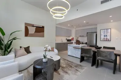 a living room with a white couch and a table at 313 Downtown Luxury Living at it's Finest in Dubai