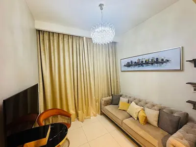a living room with a couch and a chandelier at Burj Khalifa Skyline View in Dubai