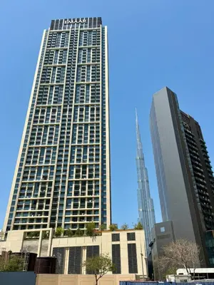 a tall building with a sign on the side of it at Luxury 1BR studio with Scenic view near Dubai mall in Dubai