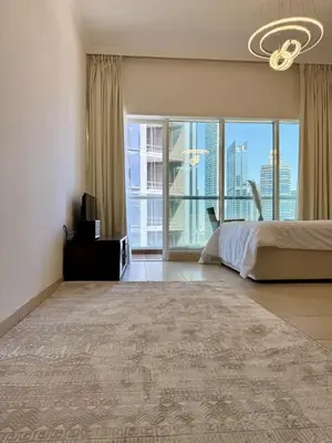 a bedroom with a large bed and a large window at Luxury 1BR studio with Scenic view near Dubai mall in Dubai