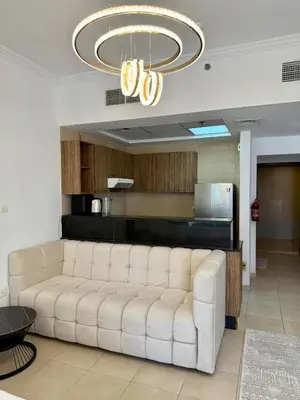 a living room with a white couch and a chandelier at Luxury 1BR studio with Scenic view near Dubai mall in Dubai