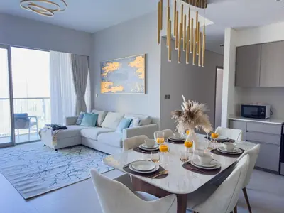 a dining room and living room with a table and chairs at GRANDE SIGNATURE with a direct Burj Khalifa view and Private Fountain Show at high floor with DXB AIRPORT VIP Shuttle option for 6 guests in Dubai