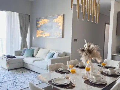 a living room with a table and a couch at GRANDE SIGNATURE with a direct Burj Khalifa view and Private Fountain Show at high floor with DXB AIRPORT VIP Shuttle option for 6 guests in Dubai