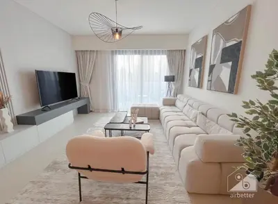 a living room with a large couch and a tv at Burj Crown Luxury 2BR I Balcony & Panoramic Views in Dubai