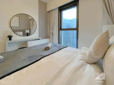 a bedroom with a large bed and a mirror at Burj Crown Luxury 2BR I Balcony & Panoramic Views in Dubai
