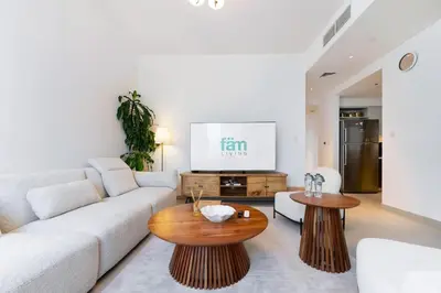 a living room with a couch and a table at FAM Living - 3BR Creekside Escape in Creek Rise Tower 2 in Dubai