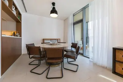 a kitchen and dining room with a table and chairs at FAM Living - 3BR Creekside Escape in Creek Rise Tower 2 in Dubai