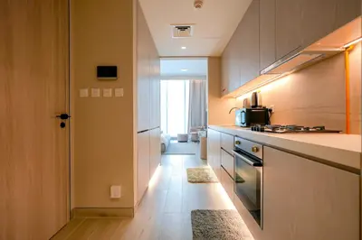 a kitchen with a sink and a stove top oven at Stylish Studio at Concord Concept, JVC in Dubai