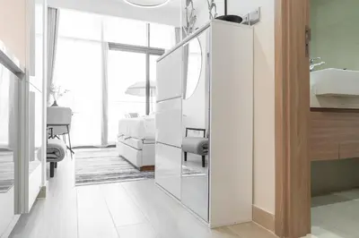 a bathroom with a mirror next to a bedroom at Chic and comfortable Studio Near Downtown and Canal in Dubai