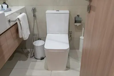 a bathroom with a white toilet and a sink at Chic and comfortable Studio Near Downtown and Canal in Dubai