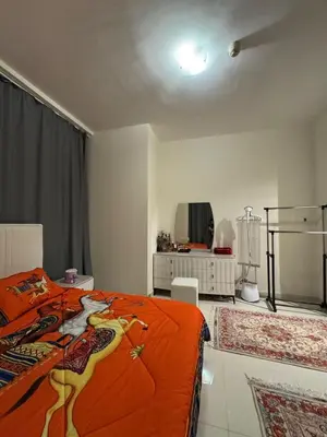 a bedroom with an orange bed and a mirror at Elegant Master bedroom with view in Dubai