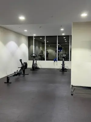 a gym with several treadmills and mirrors at Elegant Master bedroom with view in Dubai