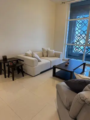 a living room with a couch and a table at Elegant Master bedroom with view in Dubai