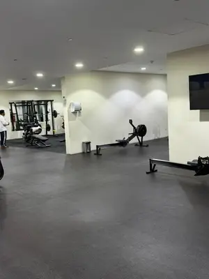 a gym with several people exercising on tread machines at Elegant Master bedroom with view in Dubai