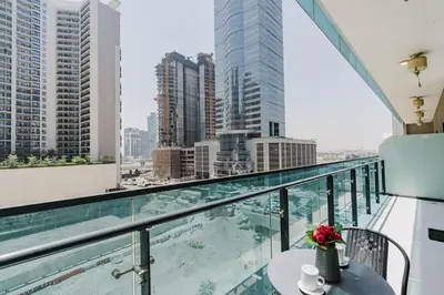 a balcony with a table and a view of a city at RH- Elegant & Cozy 1BR , Prime Location , Walk to Metro Station in Dubai