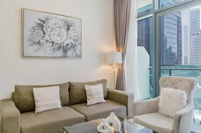 a living room with a couch and a chair at RH- Elegant & Cozy 1BR , Prime Location , Walk to Metro Station in Dubai