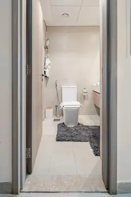 a bathroom with a toilet and a sink at Cosy studio Free Parking Free unlimited drinkable water Near Downtown in Dubai