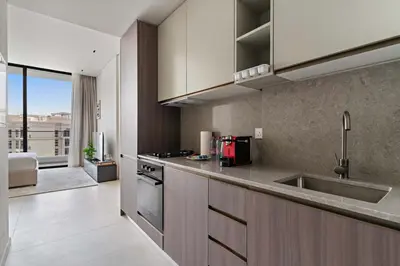 a kitchen with a sink and a counter top at Chic Studio in Arjan with Gym Pool Free parking in Dubai
