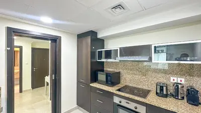 a kitchen with a counter top with a microwave at Relaxing Marina View Stay, Walk to Beach & Mall - 27AB02 in Dubai