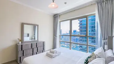 a bedroom with a bed and a large window at Relaxing Marina View Stay, Walk to Beach & Mall - 27AB02 in Dubai