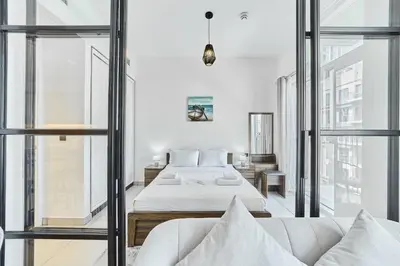 a bedroom with a bed and a couch at Chic 1BR in Socio Dubai Hills Near Park and Mall in Dubai