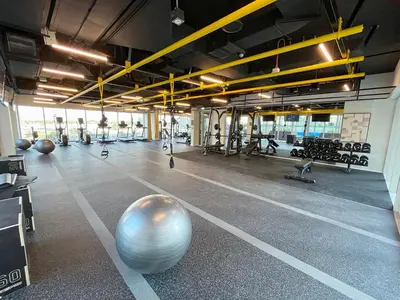 an empty gym with a large exercise ball in the middle at Chic 1BR in Socio Dubai Hills Near Park and Mall in Dubai