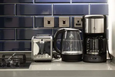 a kitchen counter with a coffee maker and a blender at Luxury Studio mints Walk to Dubai Mall & Burj Khalifa in Dubai
