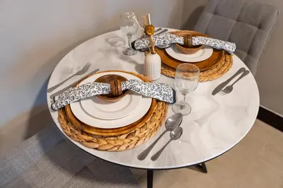 a white table with plates and silverware on it at Urban Studio Apartment in Goldcrest Views JLT in Dubai