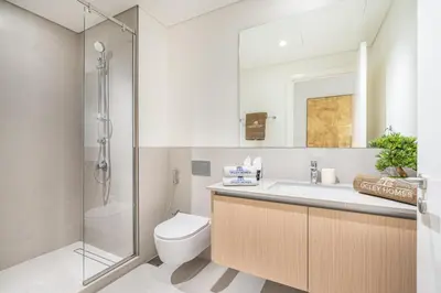 a bathroom with a toilet and a sink and a shower at Premium Home in Creek Beach with Lagoon Access in Dubai