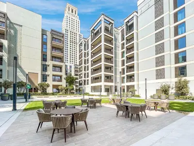 a patio with tables and chairs and tall buildings at Premium Home in Creek Beach with Lagoon Access in Dubai