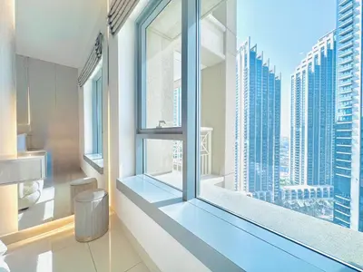 a bathroom with a large window with a view of a city at Venduras- Chic 1BR Getaway near Burj Khalifa in Dubai