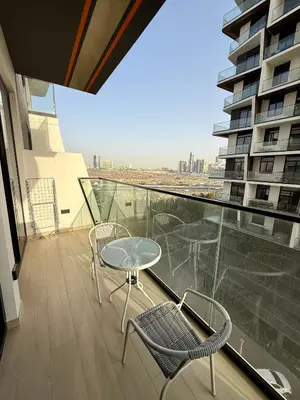 a balcony with a table and chairs on a building at Smart & Stylish 1BHK With Keyless Entry! in Dubai