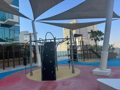 a playground in a building with a slide at Cozy studio Pet Friendly Pool, Gym, Water Near Downtown in Dubai