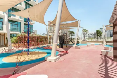 a building with a swimming pool with a canopy at Cozy studio Pet Friendly Pool, Gym, Water Near Downtown in Dubai