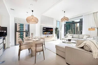a living room with a couch and a table at Mahogany 11 - 2BR 10 Guests - Walk to Burj Khalif in Dubai