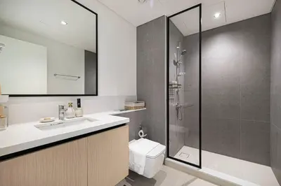 a bathroom with a shower and a toilet and a sink at Mahogany 11 - 2BR 10 Guests - Walk to Burj Khalif in Dubai