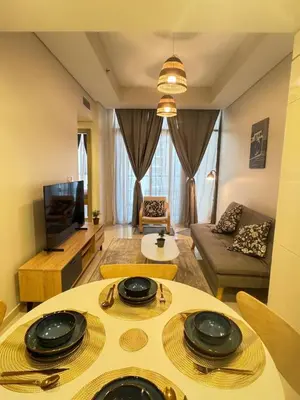 a living room with a table and a couch at Samani vacation homes 3108 canal view in Dubai