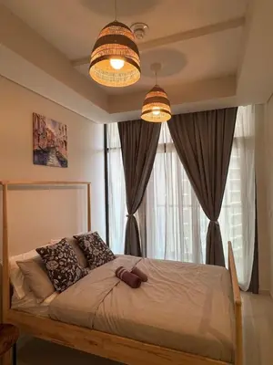 a bedroom with a bed with two lamps and a window at Samani vacation homes 3108 canal view in Dubai