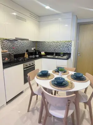 a kitchen with a table and chairs in a kitchen at Samani vacation homes 4906 canal view in Dubai