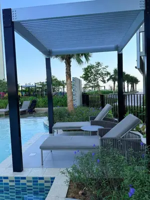 a pavilion with a table and chairs next to a pool at Samani vacation homes 4906 canal view in Dubai