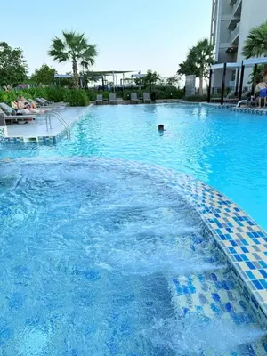 a swimming pool with blue water in a hotel at Samani vacation homes 4906 canal view in Dubai