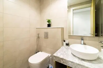 a bathroom with a white toilet and a sink at Samani vacation homes 5210 ocean view in Dubai